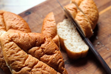 Baked bread placed on a wooden table. Flat-lat photo.