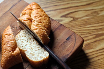 Baked bread placed on a wooden table. Flat-lat photo.