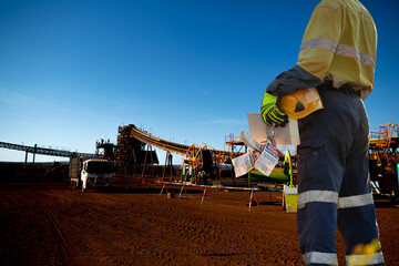 Safe work practises miner worker wearing work uniform safety glove holding hard hat danger personal...