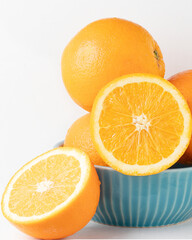 Bahia orange on a blue bowl isolated on white background.