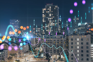 Illuminated cityscape of Los Angeles downtown at night, California, USA. Skyscrapers of LA city. Glowing forex graph hologram. The concept of internet trading, brokerage and fundamental analysis