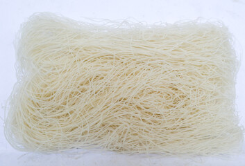 raw dry bihun or vermicelli or  rice noodles or angel hair isolated on white background

