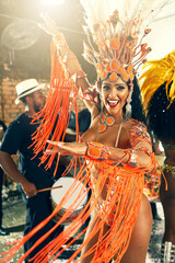 Let the beat take you away. Cropped portrait of a beautiful samba dancer performing at Carnival with her band.