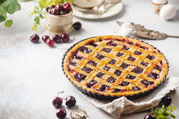 Delicious homemade classic cherry pie with a flaky crust on white background