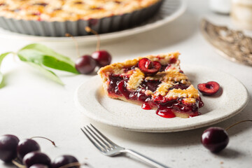 piece of Delicious homemade classic cherry pie with a flaky crust on white background