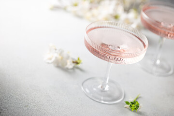 Homemade pink vodka cosmopolitan cocktail drink in crystal glasses - obrazy, fototapety, plakaty