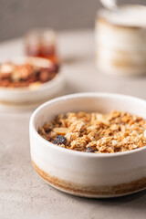 Delicious homemade granola in a bowl on gray background. Breakfast. Healthy food sweet dessert snack. Diet nutrition concept. Vegetarian food.