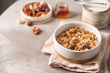 Delicious homemade granola in a bowl on gray background. Breakfast. Healthy food sweet dessert snack. Diet nutrition concept. Vegetarian food.