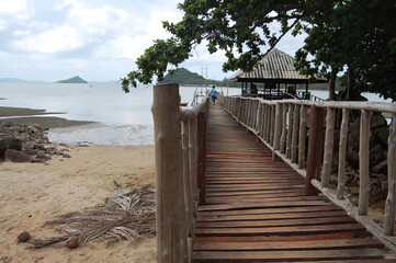 View landscape wooden bridge and boat pier go to Koh Pitak or Ko Phithak Island in Gulf of Thailand for eco tourism for thai people foreign travelers travel visit and rest relax homestay at Chumphon
