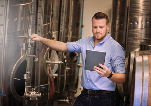 If You Dont Have A Solution, Find One Online. Shot Of A Male Sommelier Using His Digital Tablet At Work.