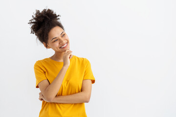 Portrait of beautiful African American young woman smiling and looking away on a white background with copy space, smiles friendly