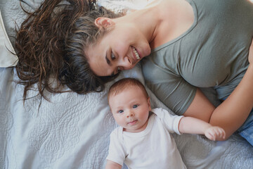 From womb-mate to room-mate. Shot of a young woman bonding with her baby boy at home.