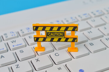 Laptop keyboard with caution sign. Maintenance, repair, under construction and safety concept.