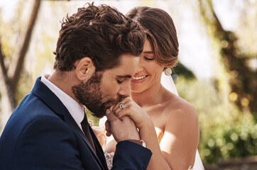 Im surely the luckiest man on earth. Cropped shot of an affectionate young bridegroom kissing his...