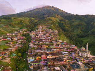 Colorful painted houses in the village are built on the slopes of a mountain. The village was named...