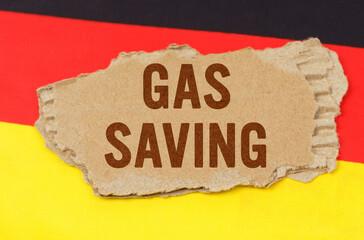 On the flag of Germany lies a cardboard plate with the inscription - gas saving