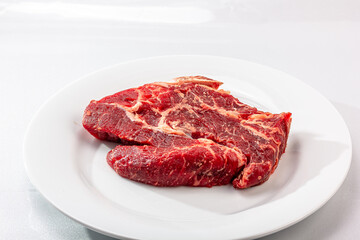 Raw marbled beef on a a white background