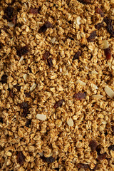 Homemade Granola with raisins and almonds background, top view.