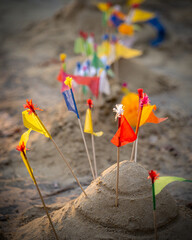 Making sand into the shape of a pagoda and put small colorful flags. One of activities of Thai people in Songkran festival or Thai New year day.