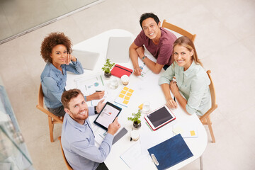 Weve got this project covered. High angle portrait of a group of businesspeople working together around a table in an office.