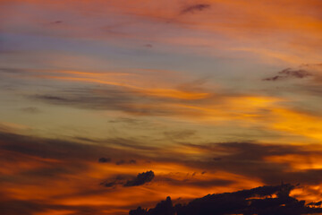 beautiful dramatic sunset sky, bright sunlight and dark silhouette of clouds as a background