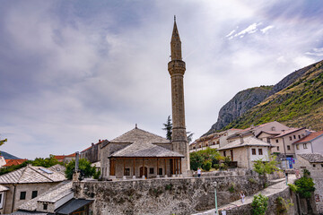 Beautiful view of an old ancient stone build mosque into the mountains at Mostar