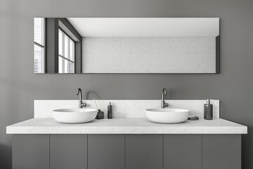 Fototapeta na wymiar Grey bathroom interior with sink and mirror, accessories on deck