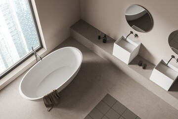 Top view of light bathroom interior with tub, window on city view