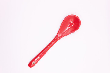 Red spoon on white background