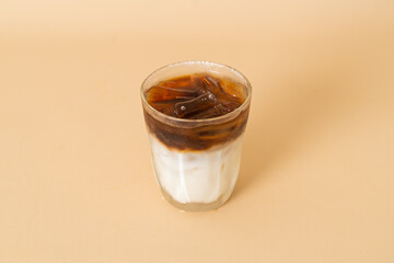iced coffee with milk layer in glass