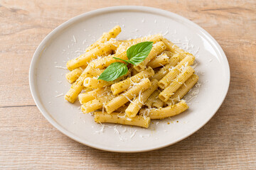 pesto rigatoni pasta with parmesan cheese