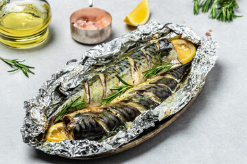 baked mackerel fish with lemon herbs and spices on a light background, banner, Food recipe...