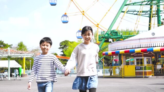 遊園地で遊ぶアジア人の家族