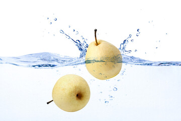 Yellow pear fruit falling in water with splash isolated on white background. © NIKCOA