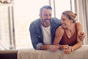 All you need is love and laughter. Shot of a happy couple relaxing on the sofa at home.