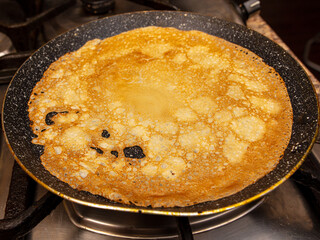 Pancakes from liquid dough are fried