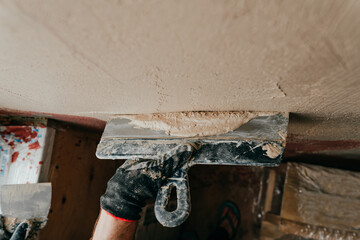 Worker applying putty mortar on the balcony wall