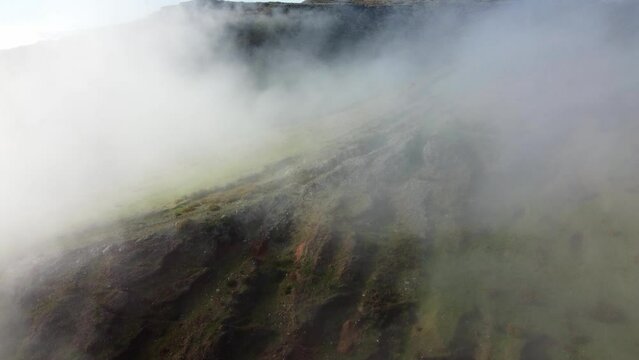 Aerial view of a foggy morning over the pastures of Ribeira Brava, Tabua on the Portuguese island of Madeira. 4k video. Foggy background