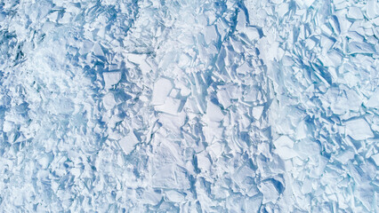 Fototapeta na wymiar Texture of beautiful white broken ice of Lake Baikal, Siberia, Russia. View from above.