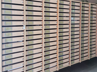 Mailboxes with modern metal boxes are located in a row.