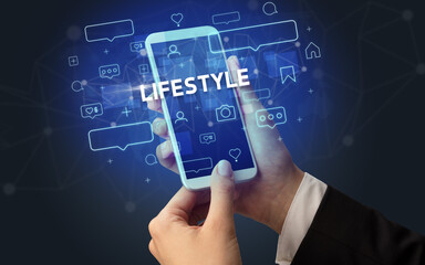 Hand using smartphone with social media concept