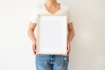 A wooden frame with empty space in women's hands