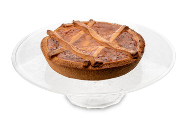 Neapolitan Pastiera on clear glass raised plate, italian cake for Easter. Filled with ricotta cheese, wheat and candied fruit,  isolated on white