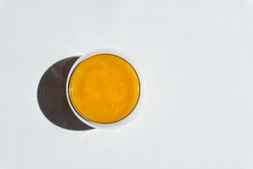 texture of golden honey in a transparent container on a white background free space for text.sunflower honey