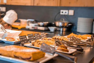 Assorted fresh delicious cake slices served in plates on counter at restaurant