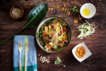 Bowl of fresh, raw, healthy salad from above. Vegetarian and nutritious food. Ready to eat. extra virgin olive oil