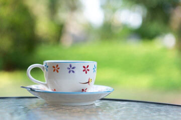 Vintage coffee cup with green nature background