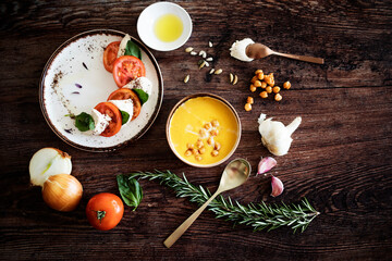 Pumpkin and chickpea cream with tomato, cheese and basil salad. Ready to eat food. Mediterranean food.