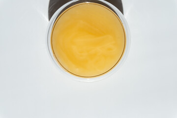 texture of yellow honey in a transparent container on a white background free space for text.cotton honey