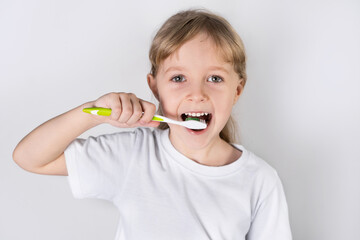 little girl brushing teeth. the concept of dental health